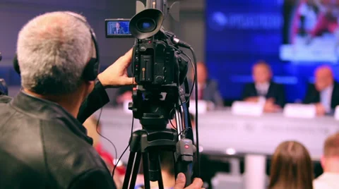 Videographer working on press conference and shooting speech Stock Footage 38162353