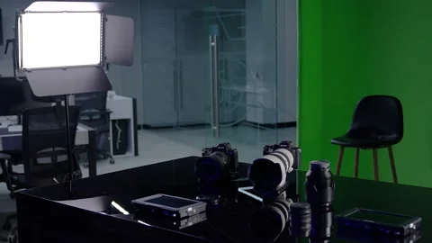 Videographer's desk. On the table are cameras and lenses, a control monitor. Stock Footage 235845929