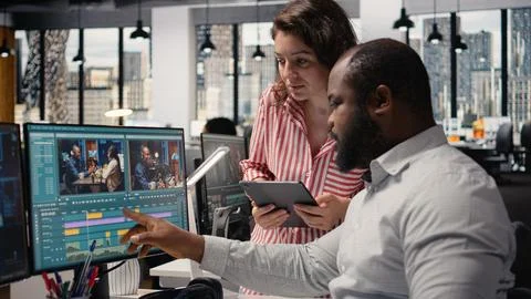 Videographers team using AI software tools for video editing on PC Stock Photos