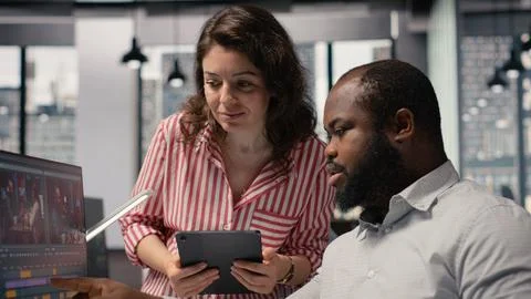 Videographers team using AI software tools for video editing on PC Stock Photos