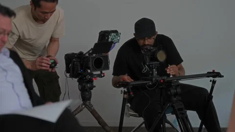 Videography Crew Preparing Interview Setup for Small-Scale Commercial Video stock 325324412