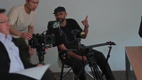 Videography Crew Preparing Interview Setup for Small-Scale Commercial Video stock 325324416