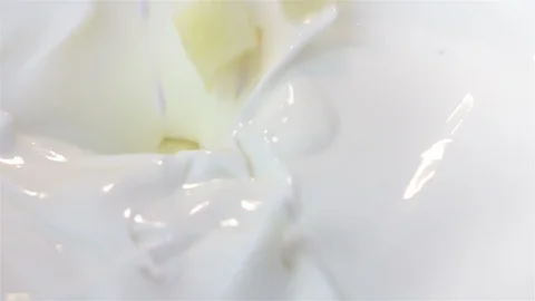 Videos of piece of pineapple falling into yogurt in real slow motion Vidéo 86174792