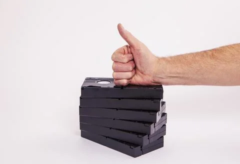Videotapes are black without boxes in their hands on a white background Stock Photos