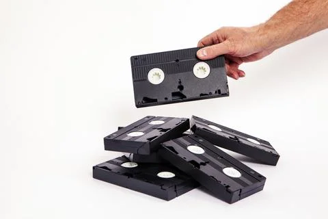Videotapes are black without boxes in their hands on a white background Stock Photos