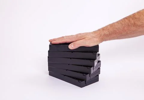 Videotapes are black without boxes in their hands on a white background Stock Photos