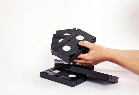 Videotapes are black without boxes in their hands on a white background Stock Photos