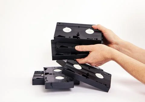 Videotapes are black without boxes in their hands on a white background Stock Photos