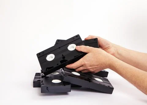 Videotapes are black without boxes in their hands on a white background Stockfoto's