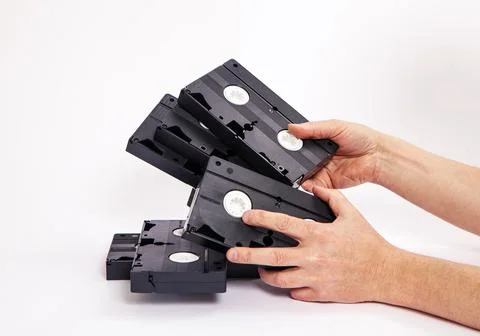 Videotapes are black without boxes in their hands on a white background Stock Photos
