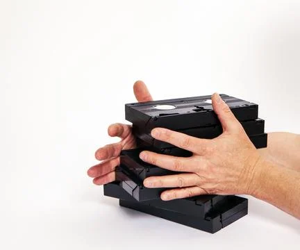 Videotapes are black without boxes in their hands on a white background Stock Photos