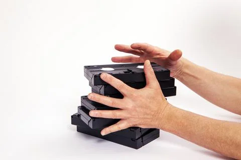Videotapes are black without boxes in their hands on a white background Stock Photos