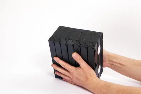 Videotapes are black without boxes in their hands on a white background Stock Photos