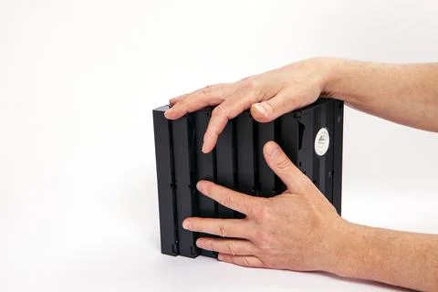 Videotapes are black without boxes in their hands on a white background Stock Photos