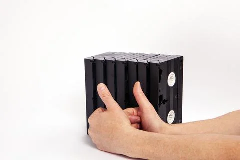 Videotapes are black without boxes in their hands on a white background Stock Photos