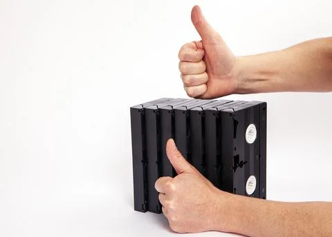 Videotapes are black without boxes in their hands on a white background Stock Photos