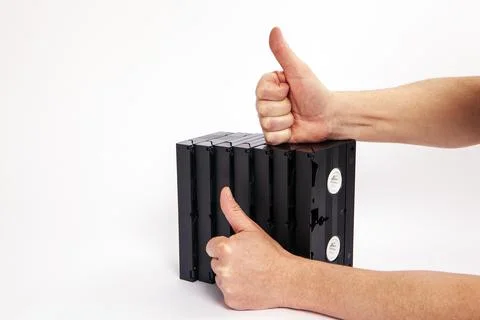 Videotapes are black without boxes in their hands on a white background Stock Photos