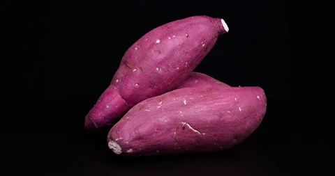 Videotaping the sweet potatoes while slowly turning them. Video stock 198307189
