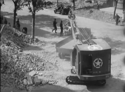 VIENNA, AUSTRIA - 1945: Rubble loading - White-star shovel loads waiting trucks Stock Footage 344486313