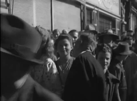 VIENNA, AUSTRIA - 1945: Waiting crowd - Faces in hats and headscarves Stock Footage 344486334