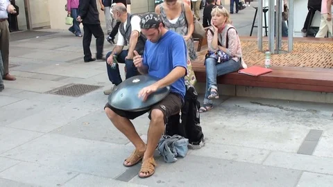 VIENNA, AUSTRIA – SEPTEMBER 30, 2011: A young musician playing a hang drum Stock Footage 78703115
