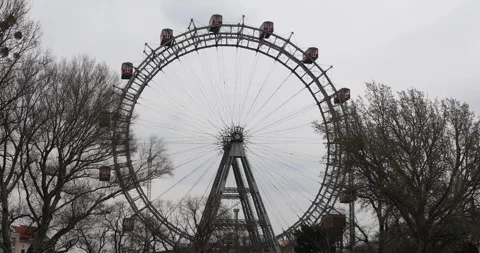 The Vienna Ferris Wheel surrounded by trees on a cloudy day Stock Footage 306140287