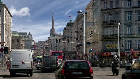 Vienna road alignment with Stephansdom in the background – long lens – SKY Stock Footage 74377030