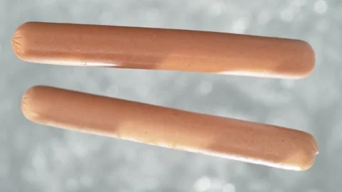 Vienna Sausage Falling into Pot of Boiling Water Stock Footage 271399307