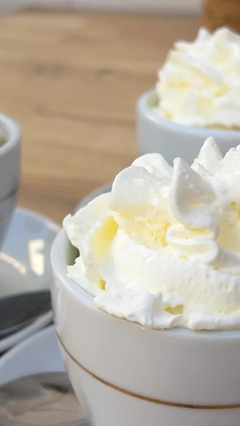 Viennese coffee three mugs of coffee with cream women decorate on a wooden table Stock Footage 292973175