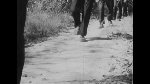 Viet cong charge across field, firing M-16 rifle - 1967 Stock Footage 103990708