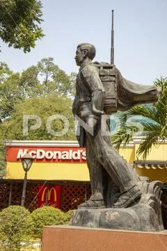 Viet Cong soldier statue and McDonalds sign in Ho Chi Minh City Vietnam Stock Photos