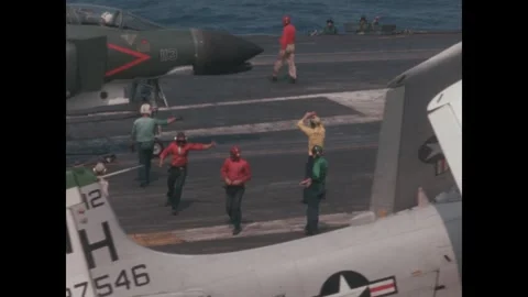 VIetnam 1960s: Flight deck operations on a U.S. Navy aircraft carrier. Crew Stock Footage 330302229