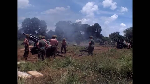 VIETNAM - 1966 - A crewman discards empty shells, tossing them away, as a Stock Footage 316678446