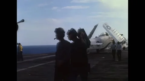 VIETNAM - 1966 - Multiple navy planes land on the carrier's deck with the help Stock Footage 296689772