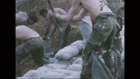 VIETNAM - 1968: Firebase Work - Soldier bends over a shovel handle Vidéo 343999262