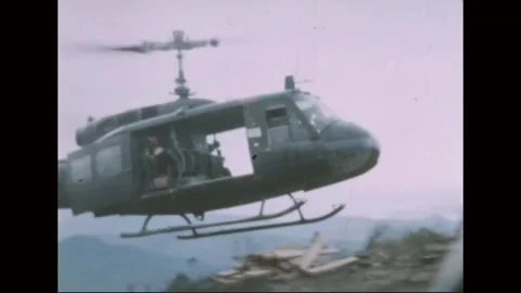VIETNAM - 1968: Firebase Work - UH-1 lifts clear of the hilltop 库存影片 343999172