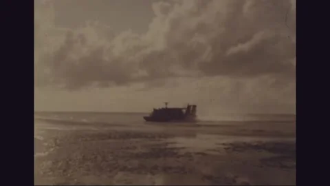 VIETNAM - 1968: Hovercraft throws spray across a delta mud flat Stock Footage 341698283