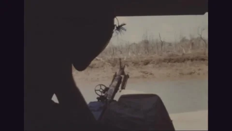VIETNAM - 1968: Machine gun framed in a hovercraft hatch Stock Footage 341698310