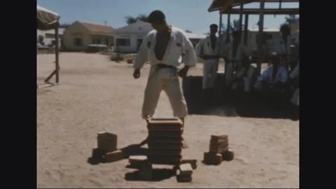 VIETNAM - 1968: Tile Stack Stance - Trainee Stands Astride a Tile Stack Stock Footage 344004989