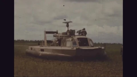 VIETNAM - 1968: Troops handle gear at a hovercraft ramp Stock Footage 341698321