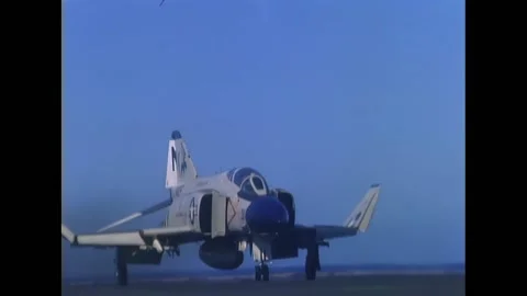 VIETNAM - 1968 - Two men load missiles onto a cart, transporting them to the Stock Footage 296694674