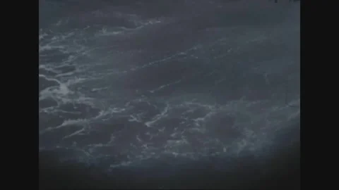 VIETNAM - 1969: Patrol wake study - foam boils beside a dark hull Stock Footage 343940677