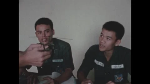 VIETNAM - 1970: Close model shot - Model held close to a trainee's face 库存影片 344004064