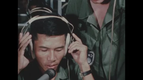 VIETNAM - 1970: Headset fitting - Trainee is fitted with a headset Vidéo 344004089