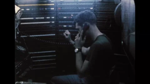 VIETNAM - 1970: Switchboard operator - Soldier raises a hand to a jack field Stock Footage 344005493