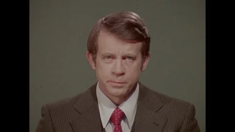 VIETNAM 1970s: A man with combed-back hair speaks directly to the camera against Stock Footage 342137139