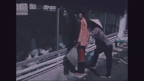 VIETNAM - 1971: Poultry programme - baskets pass pens of white chickens 動画素材 343937566