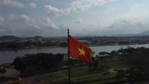 Vietnam Flag Billowing in the Wind in front of Ancient Imperial City Hue Aer Stock Footage 124960763