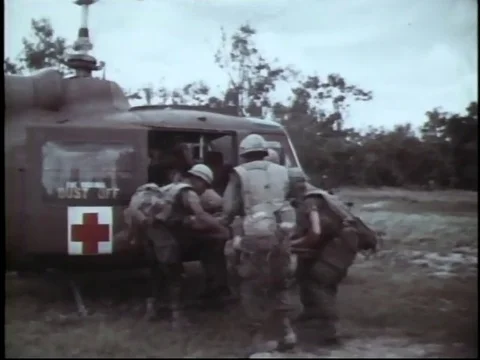 Vietnam War - Medical Helicopter lands to assist wounded soldier Stock Footage