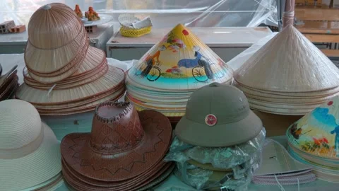 Vietnamese bamboo non la conical hats with colorful drawings and plain ones Stock-Footage 333312168